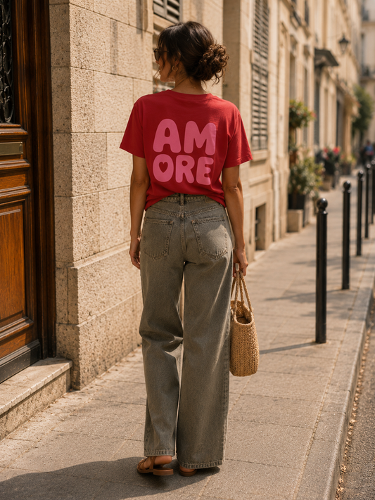 T-shirt AMORE rouge en coton porté de face.
T-shirt AMORE rouge avec imprimé AMORE au dos.
T-shirt femme rouge 100 % coton avec imprimé rose.
T-shirt AMORE rouge porté avec un jean taille haute.
T-shirt AMORE rouge porté avec une jupe colorée.